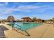 Community pool features lounge chairs, desert landscaping, and shade structures at 10758 E Peralta Canyon Dr, Gold Canyon, AZ 85118