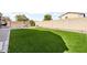 Backyard featuring artificial turf and block wall fencing, creating a private outdoor space at 10840 W Saddlehorn Rd, Peoria, AZ 85383