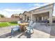 Spacious backyard showcasing a fire pit, seating, artificial turf, and a covered patio at 10840 W Saddlehorn Rd, Peoria, AZ 85383