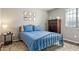 Serene bedroom featuring a metal frame bed, wooden dresser, and neutral wall décor with hardwood floors at 10840 W Saddlehorn Rd, Peoria, AZ 85383