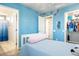 Bright blue bedroom featuring a twin bed, with walk-in closet and attached bathroom at 10840 W Saddlehorn Rd, Peoria, AZ 85383