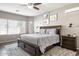 Main bedroom featuring a dark wood bed, a ceiling fan, and neutral walls at 10840 W Saddlehorn Rd, Peoria, AZ 85383