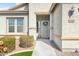 Charming front porch with decorative wreath, landscaping, and view of the front window at 10840 W Saddlehorn Rd, Peoria, AZ 85383