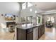 Kitchen island with stainless steel dishwasher and sink, plus seating and open floor plan at 10840 W Saddlehorn Rd, Peoria, AZ 85383