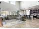 Open-concept living room with high ceilings, lots of natural light, tile floors and bar seating at the kitchen counter at 10840 W Saddlehorn Rd, Peoria, AZ 85383