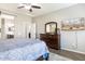 Main bedroom view including dresser with mirror and flat screen TV at 10840 W Saddlehorn Rd, Peoria, AZ 85383