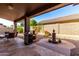 Inviting covered back patio features a grill and a water fountain at 11056 E Nopal Ave, Mesa, AZ 85209