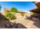 Backyard showcases a rock feature and low-maintenance gravel landscaping at 11056 E Nopal Ave, Mesa, AZ 85209