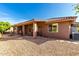 Backyard with covered patio and low-maintenance gravel landscaping at 11056 E Nopal Ave, Mesa, AZ 85209