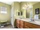 Bathroom features double sinks, wooden cabinets, and great natural light at 11056 E Nopal Ave, Mesa, AZ 85209