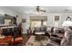 Cozy living room featuring a ceiling fan, stylish rug, and comfortable seating at 11056 E Nopal Ave, Mesa, AZ 85209