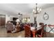 Open-concept living room and dining area featuring a chandelier and tile flooring at 11056 E Nopal Ave, Mesa, AZ 85209