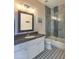 Modern bathroom featuring a stylish vanity, patterned flooring, and tiled shower with glass doors at 11656 N 135Th Pl, Scottsdale, AZ 85259