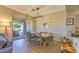 Dining area with modern lighting, wood floors, and view to outdoor patio seating at 11656 N 135Th Pl, Scottsdale, AZ 85259