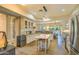 Well-lit kitchen featuring stainless steel appliances, a center island with seating, and modern finishes at 11656 N 135Th Pl, Scottsdale, AZ 85259