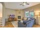 Cozy living room with a fireplace, plush seating, and a view to the outdoor patio at 11656 N 135Th Pl, Scottsdale, AZ 85259