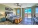 Bedroom features a ceiling fan, wood floors, and a sliding glass door at 11656 N 135Th Pl, Scottsdale, AZ 85259