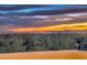 Picturesque sunset vista with city lights twinkling below the horizon, visible from an elevated vantage point at 11656 N 135Th Pl, Scottsdale, AZ 85259