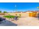 Relaxing backyard featuring a patio, a lush lawn, mature trees, and secure fencing at 1206 E Loyola Dr, Tempe, AZ 85282