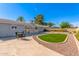 Spacious backyard featuring a lush lawn, mature trees, and ample space for outdoor entertaining at 1206 E Loyola Dr, Tempe, AZ 85282