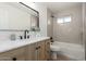 Bright bathroom featuring a light wood vanity, modern fixtures, and a shower-tub combination at 1206 E Loyola Dr, Tempe, AZ 85282