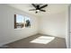 Bright bedroom with a ceiling fan and a large window letting in plenty of natural light at 1206 E Loyola Dr, Tempe, AZ 85282