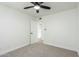 A spacious bedroom with open door to hallway, carpet and ceiling fan at 1206 E Loyola Dr, Tempe, AZ 85282