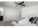 Bright bedroom featuring plush carpet, a ceiling fan, and an ensuite bathroom, creating a comfortable, modern space at 1206 E Loyola Dr, Tempe, AZ 85282