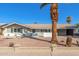 Charming single-story home featuring desert landscaping, a brick accent wall, and a private carport at 1206 E Loyola Dr, Tempe, AZ 85282