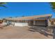 Charming single-story home featuring desert landscaping, a brick accent wall, and a private carport at 1206 E Loyola Dr, Tempe, AZ 85282