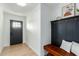 Inviting foyer features wood-look tile flooring, black accents and a convenient bench at 1206 E Loyola Dr, Tempe, AZ 85282