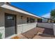 Stylish front entrance with dark-stained door and modern sconce lighting at 1206 E Loyola Dr, Tempe, AZ 85282