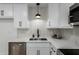 Bright kitchen with white cabinetry, stainless steel appliances, and modern black hardware at 1206 E Loyola Dr, Tempe, AZ 85282