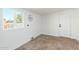 Simple laundry room with white walls, concrete floors and a window with natural light at 1206 E Loyola Dr, Tempe, AZ 85282