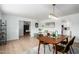 Open-concept living room with wood-look floors, dining area, and comfortable seating, creating a welcoming space at 1206 E Loyola Dr, Tempe, AZ 85282