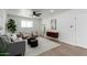 Bright living room with gray sofa, chairs, and a dark wood accent cabinet at 1206 E Loyola Dr, Tempe, AZ 85282