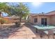 The backyard features low maintenance landscaping and a large patio with a dining set at 12601 S Tonto Ct, Phoenix, AZ 85044