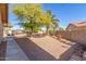 Large private backyard with low maintenance landscaping, a patio, and beautiful desert trees at 12601 S Tonto Ct, Phoenix, AZ 85044