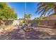 Relax in this cozy backyard with a firepit, seating, and desert landscaping at 12601 S Tonto Ct, Phoenix, AZ 85044