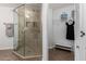 Bathroom featuring glass shower door, tiled shower walls, and built-in shelving at 12601 S Tonto Ct, Phoenix, AZ 85044