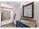 Bathroom featuring modern vanity with granite countertop and tiled shower with showerhead at 12601 S Tonto Ct, Phoenix, AZ 85044