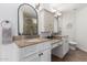 Bright bathroom featuring double vanity, granite countertop and modern fixtures at 12601 S Tonto Ct, Phoenix, AZ 85044