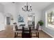 Cozy dining area with a modern chandelier fixture and views into kitchen at 12601 S Tonto Ct, Phoenix, AZ 85044