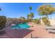 Private pool with a Baja shelf, desert landscaping, and plenty of deck space for lounge chairs at 12601 S Tonto Ct, Phoenix, AZ 85044