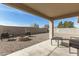 Outdoor patio area featuring low-maintenance landscaping, a fire pit, and a covered patio at 13267 W Port Au Prince Ln, Surprise, AZ 85379