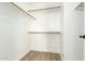 Walk-in closet with white walls and wood laminate flooring at 13267 W Port Au Prince Ln, Surprise, AZ 85379