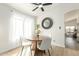 Bright dining area featuring hardwood floors, modern decor, and a view of the backyard at 13267 W Port Au Prince Ln, Surprise, AZ 85379