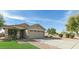 Charming single-story home featuring a neutral color palette, well-maintained landscaping, and a spacious two-car garage at 13267 W Port Au Prince Ln, Surprise, AZ 85379