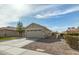 Charming single-story home featuring a neutral color palette, well-maintained landscaping, and a spacious two-car garage at 13267 W Port Au Prince Ln, Surprise, AZ 85379