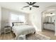 Inviting bedroom featuring a ceiling fan, ensuite bathroom, neutral tones, and bright natural light at 13267 W Port Au Prince Ln, Surprise, AZ 85379